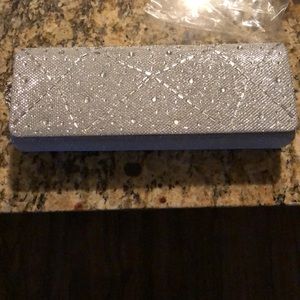 A brand new, never used glitter clutch